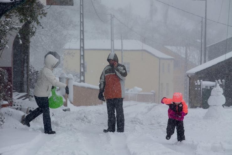 Tres persoas nunha vía nevada 